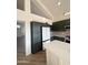 Modern kitchen with dark green cabinets, stainless steel appliances, and a large island at 6891 W Via Del Sol Dr, Glendale, AZ 85310