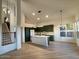 Modern kitchen with dark green cabinets, white quartz countertops, and stainless steel appliances at 6891 W Via Del Sol Dr, Glendale, AZ 85310