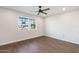 Bedroom with a large window providing natural light and a ceiling fan at 10213 W Cumberland Dr, Sun City, AZ 85351