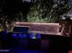 Stunning outdoor kitchen at night with grill, sink, and modern tile at 10801 N 45Th St, Phoenix, AZ 85028
