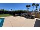 Outdoor kitchen featuring a stone fireplace, bar seating, and stainless steel BBQ grill at 10801 N 45Th St, Phoenix, AZ 85028