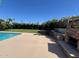 Backyard with an outdoor kitchen including bar, grill, fireplace, pool, and manicured landscaping at 10801 N 45Th St, Phoenix, AZ 85028