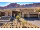 Beautiful modern home with a desert landscape and a mountain backdrop, featuring a three-car garage at 12659 E Shadow Ridge Dr, Scottsdale, AZ 85255