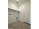 Laundry room with built-in shelving and wood-look tile floor at 12723 W Carousel Dr, Arizona City, AZ 85123