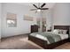 Spacious bedroom with a king-size bed and ceiling fan at 13015 W Highland Ave, Litchfield Park, AZ 85340