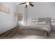 Large bedroom with a king-size bed and ceiling fan at 13015 W Highland Ave, Litchfield Park, AZ 85340