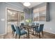 Bright dining room featuring a table with blue chairs and access to backyard at 13015 W Highland Ave, Litchfield Park, AZ 85340
