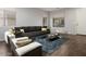 Living room featuring a comfortable sectional sofa and stylish coffee table at 13015 W Highland Ave, Litchfield Park, AZ 85340