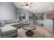 Living room with L-shaped sectional sofa and a modern coffee table at 13015 W Highland Ave, Litchfield Park, AZ 85340