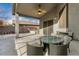 Covered patio with outdoor dining furniture and backyard view at 13015 W Highland Ave, Litchfield Park, AZ 85340