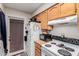White appliances and wood cabinets in this galley kitchen at 170 E Guadalupe Rd # 14, Gilbert, AZ 85234