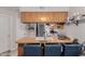 View of kitchen with wood cabinets, breakfast bar and sink at 170 E Guadalupe Rd # 14, Gilbert, AZ 85234