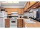 Modern kitchen with wood cabinets and white appliances at 170 E Guadalupe Rd # 14, Gilbert, AZ 85234
