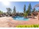 Community pool with brick patio and covered seating area at 170 E Guadalupe Rd # 14, Gilbert, AZ 85234