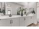 Modern bathroom with double vanity, white cabinets, and black hardware at 21211 W Minnezona Ave, Buckeye, AZ 85396