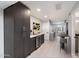 Stylish bar area featuring dark wood cabinets, wine cooler, and white countertops at 3501 N 64Th St # 24, Scottsdale, AZ 85251