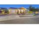 Single story home with modern facade, landscaping, and solar panels at 4825 N 205Th Gln, Buckeye, AZ 85396