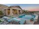 Relaxing backyard oasis with a sparkling pool, patio seating, and lush landscaping at 4825 N 205Th Gln, Buckeye, AZ 85396