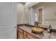Bathroom with granite countertop, vessel sink, and dark wood cabinets at 501 E Sunburst Ln, Tempe, AZ 85284