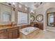 Spa-like bathroom featuring a soaking tub and double vanity at 501 E Sunburst Ln, Tempe, AZ 85284