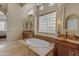 Elegant bathroom with soaking tub, double vanity, and large mirror at 501 E Sunburst Ln, Tempe, AZ 85284