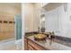 Bathroom with granite countertop, vessel sink, and shower/tub at 501 E Sunburst Ln, Tempe, AZ 85284