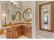 Bathroom with corner vanity and large mirror reflecting bedroom at 501 E Sunburst Ln, Tempe, AZ 85284
