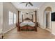 Main bedroom with four poster bed and ceiling fan, view of ensuite at 501 E Sunburst Ln, Tempe, AZ 85284