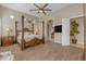 Main bedroom with four-poster bed, ensuite bathroom access, and ceiling fan at 501 E Sunburst Ln, Tempe, AZ 85284