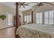 Main bedroom with four-poster bed and ceiling fan, patio door access at 501 E Sunburst Ln, Tempe, AZ 85284