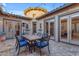 Charming courtyard with dining area, string lights, and heater at 501 E Sunburst Ln, Tempe, AZ 85284