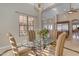 Bright dining area with glass table and four chairs, kitchen view at 501 E Sunburst Ln, Tempe, AZ 85284