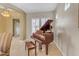 Elegant dining room with a grand piano and hardwood floors at 501 E Sunburst Ln, Tempe, AZ 85284