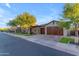 View of home's exterior, showcasing stone and wood finishes at 501 E Sunburst Ln, Tempe, AZ 85284