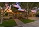 Single-story home with stone accents, wood garage doors, and landscaped yard at 501 E Sunburst Ln, Tempe, AZ 85284