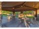 Covered picnic area with stone pillars, wooden beams, and picnic tables at 501 E Sunburst Ln, Tempe, AZ 85284