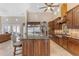 Island kitchen with granite countertops, stainless steel appliances, and custom cabinetry at 501 E Sunburst Ln, Tempe, AZ 85284