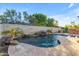 Relaxing kidney-shaped pool with a stone waterfall feature at 501 E Sunburst Ln, Tempe, AZ 85284