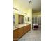 Bathroom with double vanity and decorative glass block window at 11250 E Kilarea Ave # 252, Mesa, AZ 85209