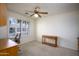 Bedroom featuring a ceiling fan, a desk, a chair, and large windows with plantation shutters at 11250 E Kilarea Ave # 252, Mesa, AZ 85209
