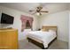 Relaxing bedroom with ceiling fan and television set at 11250 E Kilarea Ave # 252, Mesa, AZ 85209
