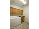 Laundry room includes washer, dryer, sink and cabinets for convenient storage at 11250 E Kilarea Ave # 252, Mesa, AZ 85209