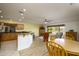 Open-concept living room and kitchen area with breakfast bar and lots of natural light at 11250 E Kilarea Ave # 252, Mesa, AZ 85209