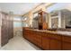 Luxurious bathroom featuring dual vanities, granite countertops, and a modern shower at 19814 N Shadow Mountain Dr, Surprise, AZ 85374