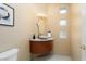 Powder room featuring an eye-catching, curved floating cabinet and framed art at 19814 N Shadow Mountain Dr, Surprise, AZ 85374