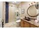 Modern bathroom with a stylish copper sink, glass shower, and elegant mirror at 19814 N Shadow Mountain Dr, Surprise, AZ 85374