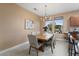 Warm dining room featuring modern decor, a chandelier, and a large window at 19814 N Shadow Mountain Dr, Surprise, AZ 85374