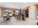 Modern kitchen and dining area with stainless steel appliances, island seating, and ample natural light at 19814 N Shadow Mountain Dr, Surprise, AZ 85374