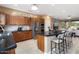 Open kitchen with granite countertops, stainless steel appliances, and a spacious island with seating at 19814 N Shadow Mountain Dr, Surprise, AZ 85374