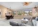 Bright living area with large windows showcasing desert views and comfortable seating at 19814 N Shadow Mountain Dr, Surprise, AZ 85374